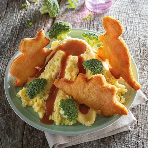 Kartoffelpüree-Vulkan mit Geflügel-Dinos und Broccoli-Bäumchen